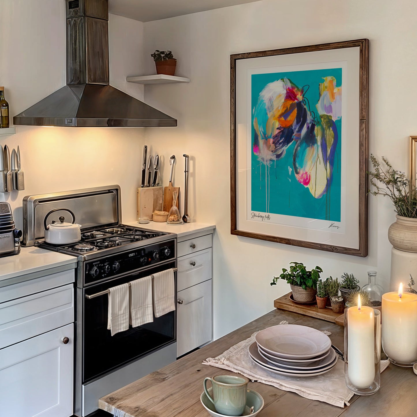 Modern kitchen with stove, cabinets, and decorative elements including a colorful painting.